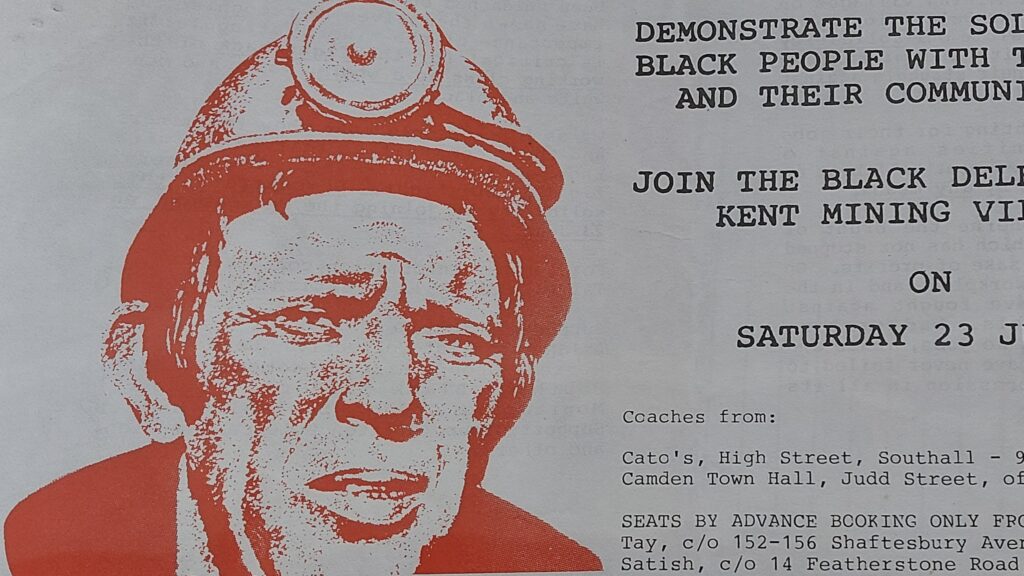 Leaflet calling for Black community support for striking miners and advertising a solidarity visit to Kent mining villages during the 1984-85 miners' strike. An image of a miner looking determined is printed in red on the left hand side.
